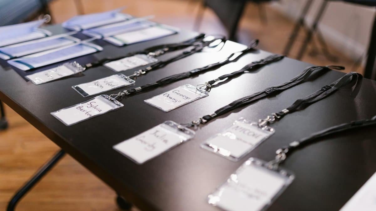 Close-up of name tags and folders laid out for a conference or meeting.