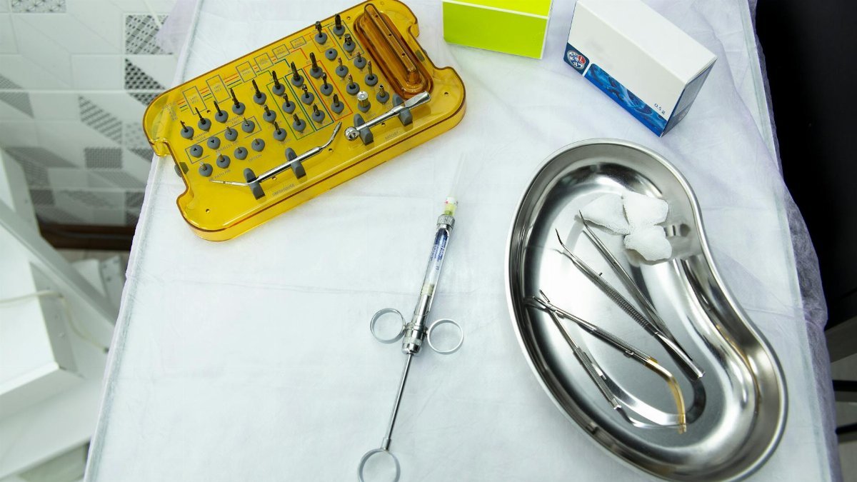 A set of dental and medical tools on a sterile tray, ideal for clinical and healthcare settings.