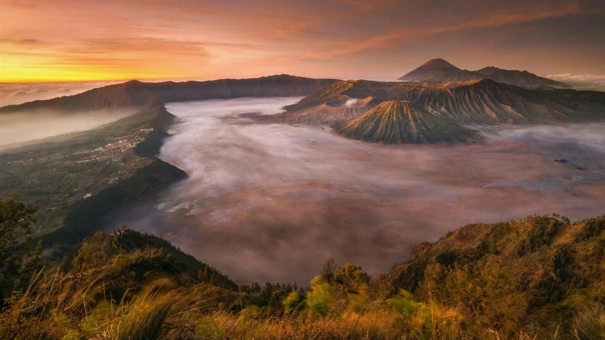 Breathtaking view of sunrise over Mount Bromo in East Java, Indonesia with vibrant colors and volcanic landscape.