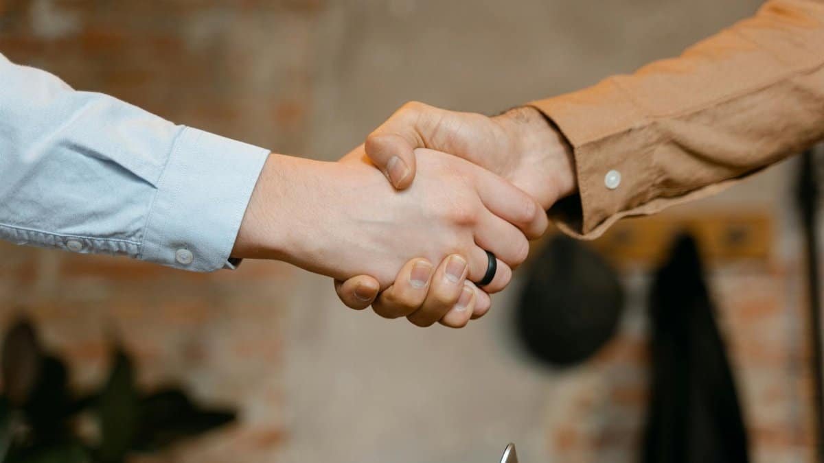 Close-up of a firm handshake symbolizing a business deal agreement.