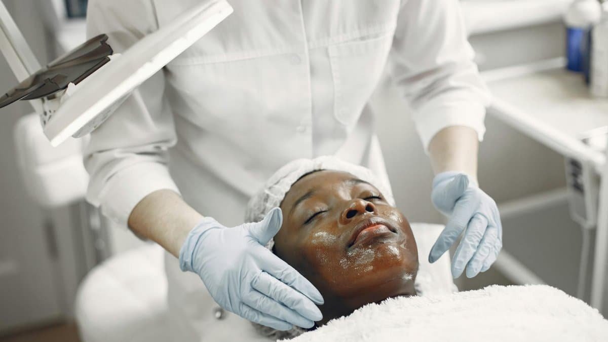 A client enjoys a soothing facial treatment in a modern skincare clinic, promoting wellness and relaxation.