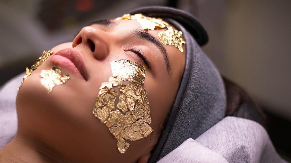 Relaxing spa experience with a gold leaf facial mask providing ultimate skincare luxury.