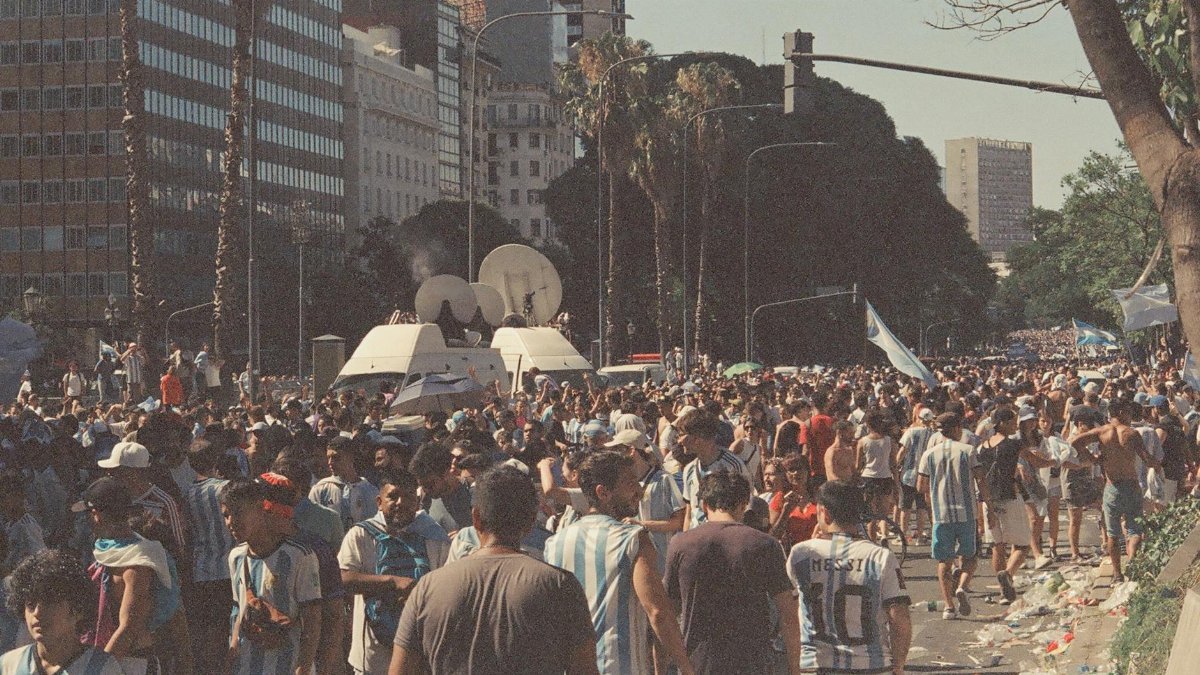 Lively street scene with football fans celebrating in Buenos Aires, Argentina.