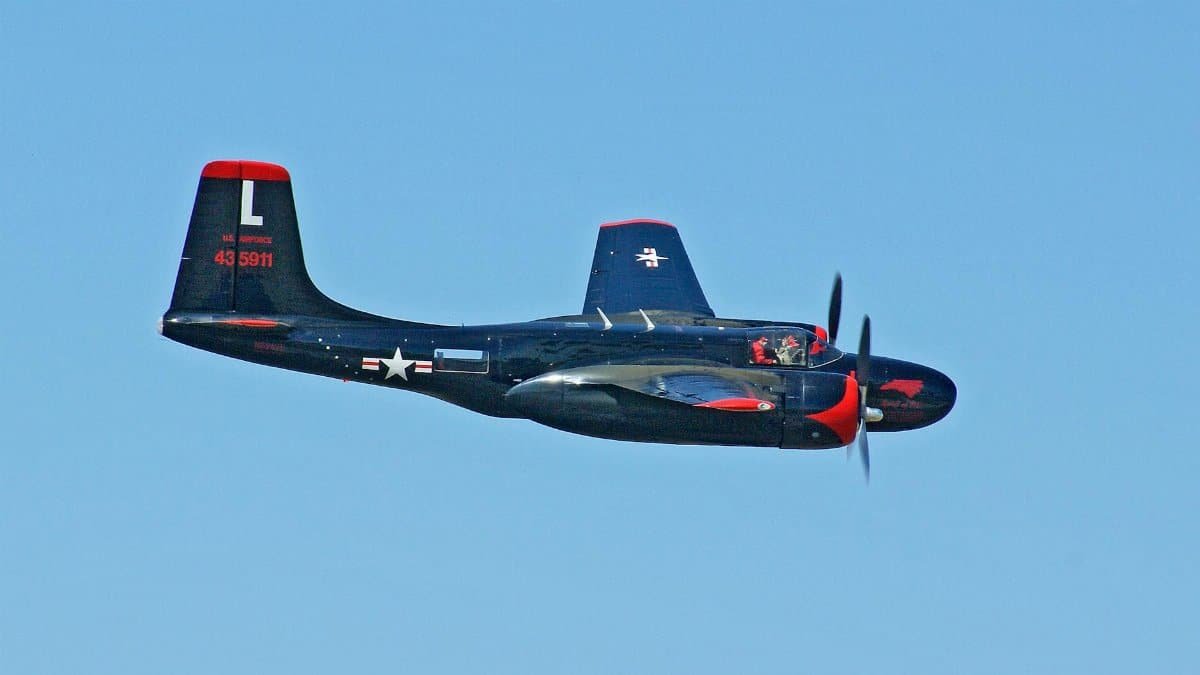 Vintage B-26 Invader aircraft in flight under clear skies, showcasing military aviation history.
