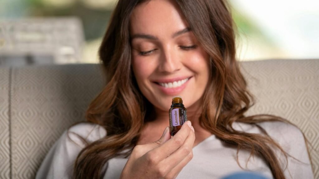 A woman enjoying the aroma of lavender essential oil, promoting relaxation and natural therapy.