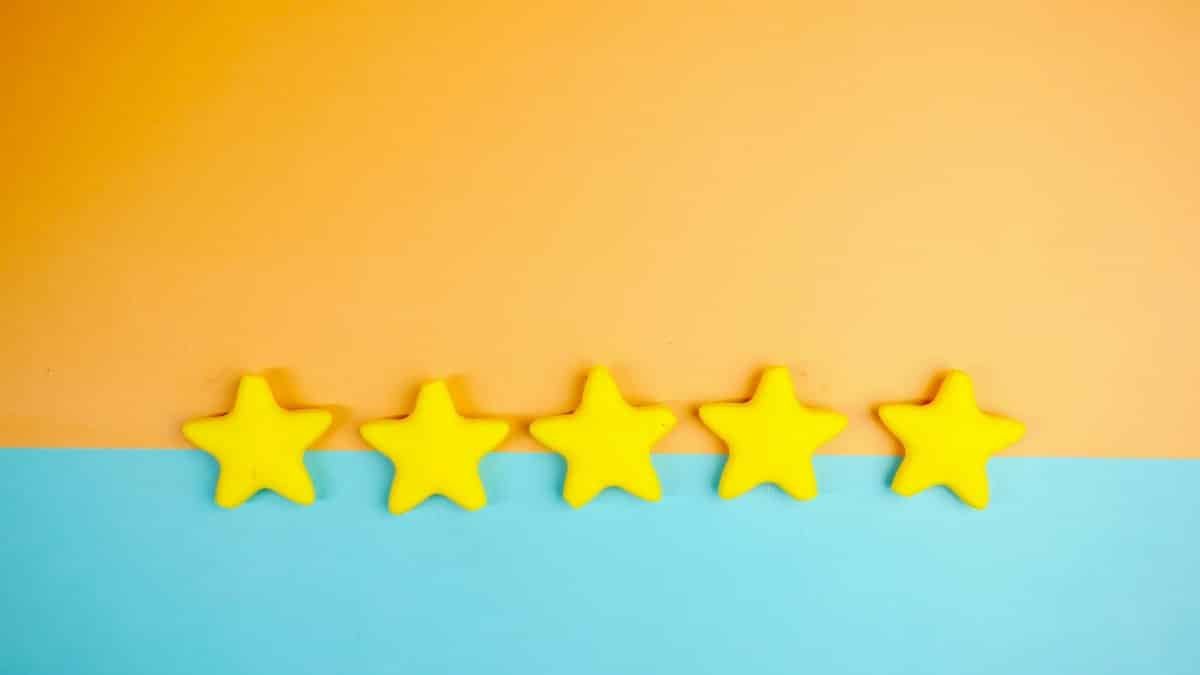 Bright yellow stars arranged on a vivid orange and blue background with copy space.