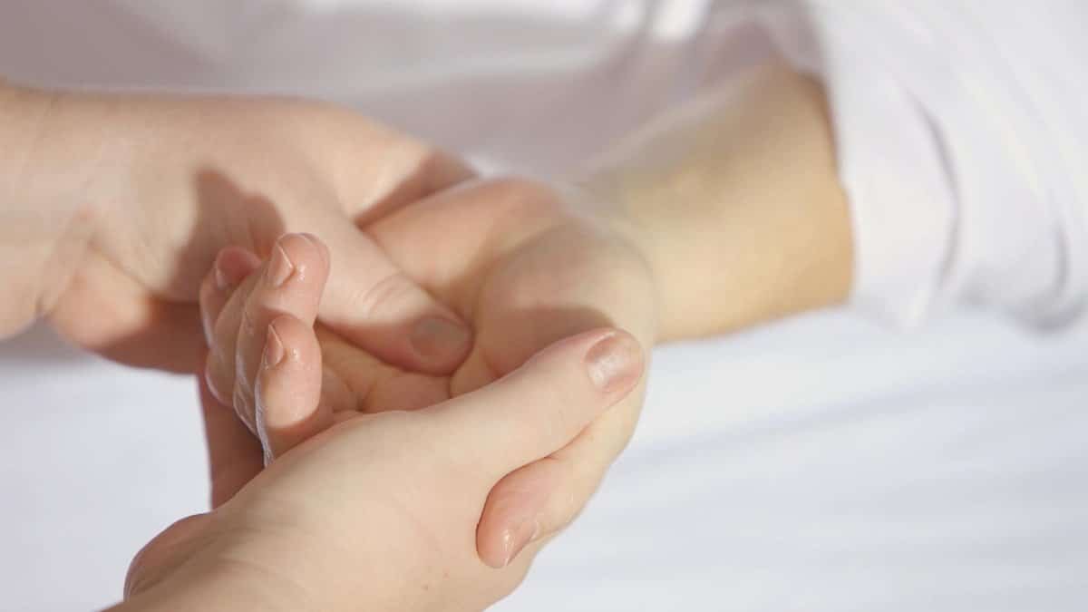 Relaxing hand massage therapy session close-up with gentle touch and care.