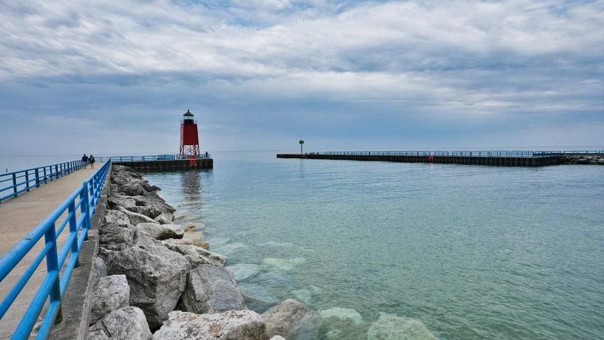 Beautiful view of Charlevoix South Pier Lighthouse with tranquil Lake Michigan waters.