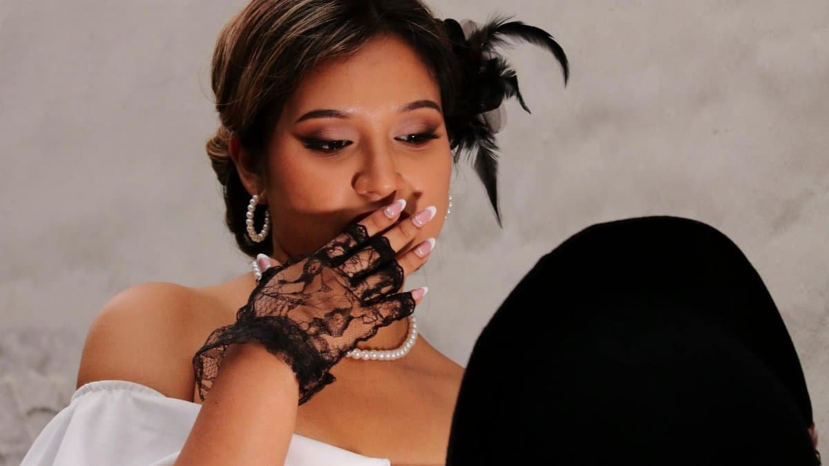 Vintage glamour portrait with elegant attire and mysterious ambiance.