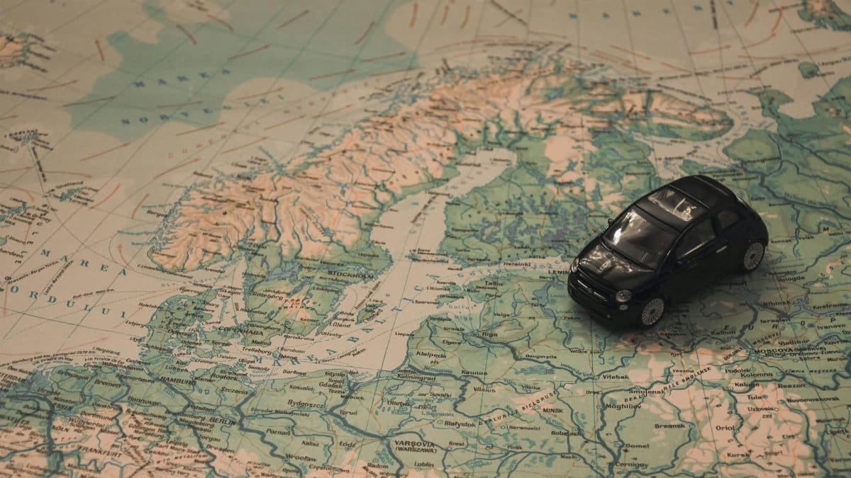 A miniature black car on a detailed map of Scandinavia, symbolizing travel adventures.