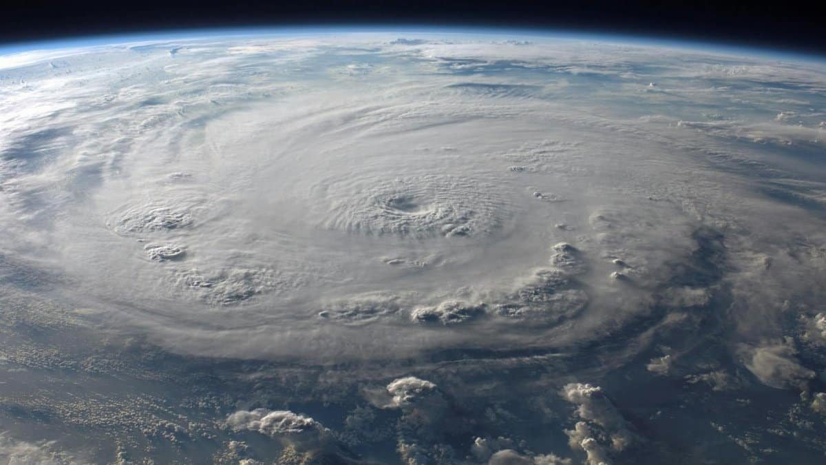 A stunning aerial view of Earth with a massive swirling hurricane, highlighting meteorological beauty.