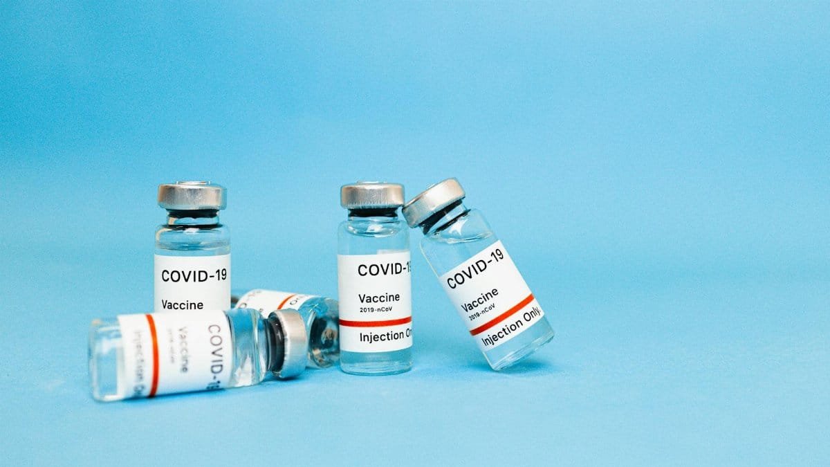 Close-up of COVID-19 vaccine vials against a blue background, symbolizing hope and recovery.