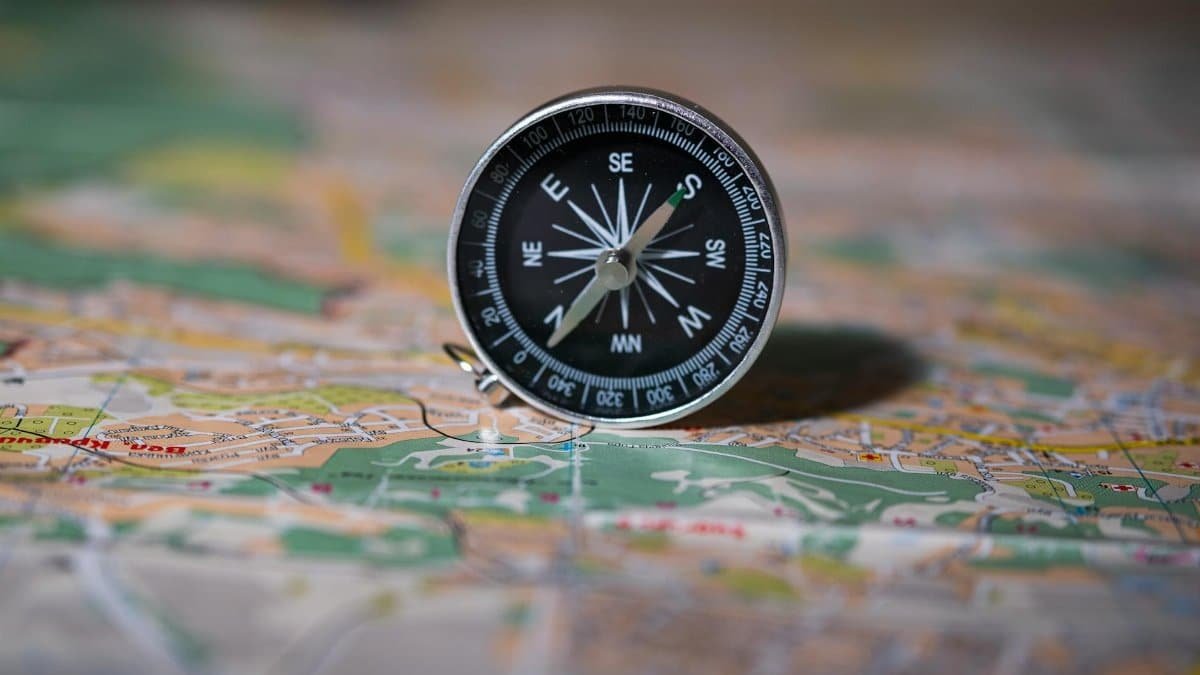 Black compass on detailed map symbolizing navigation and exploration.