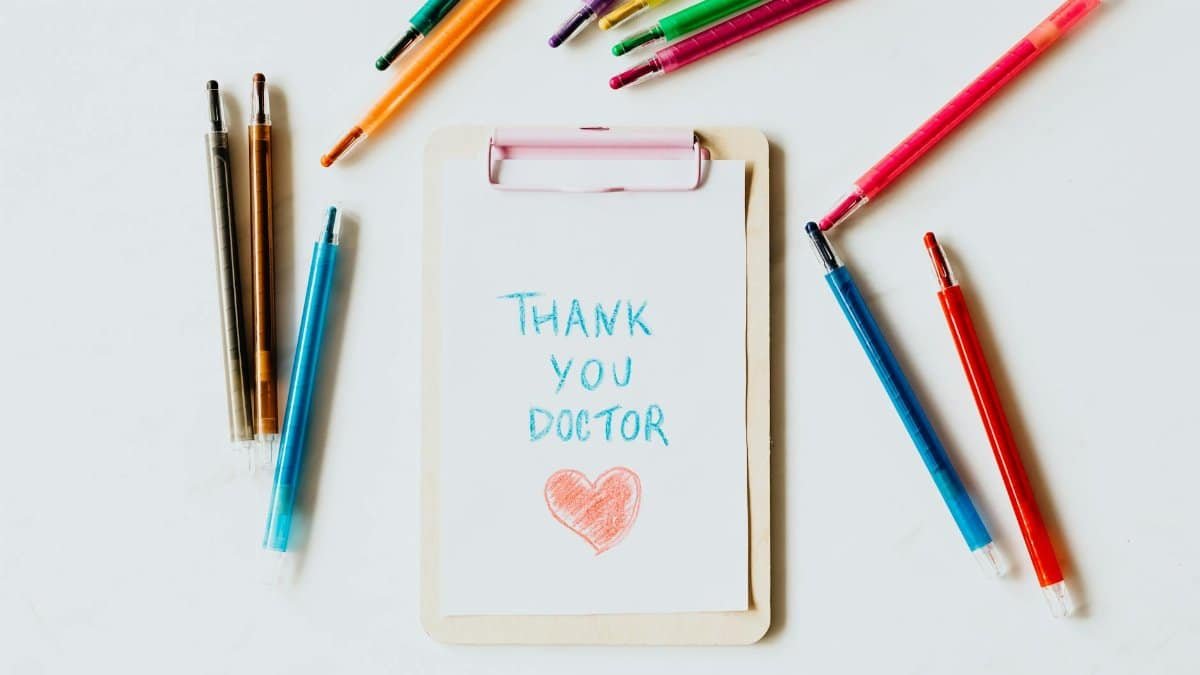 Creative thank you note for doctors on clipboard with pens symbolizing appreciation and gratitude.