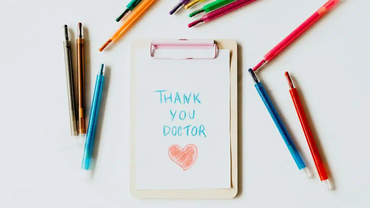 Creative thank you note for doctors on clipboard with pens symbolizing appreciation and gratitude.