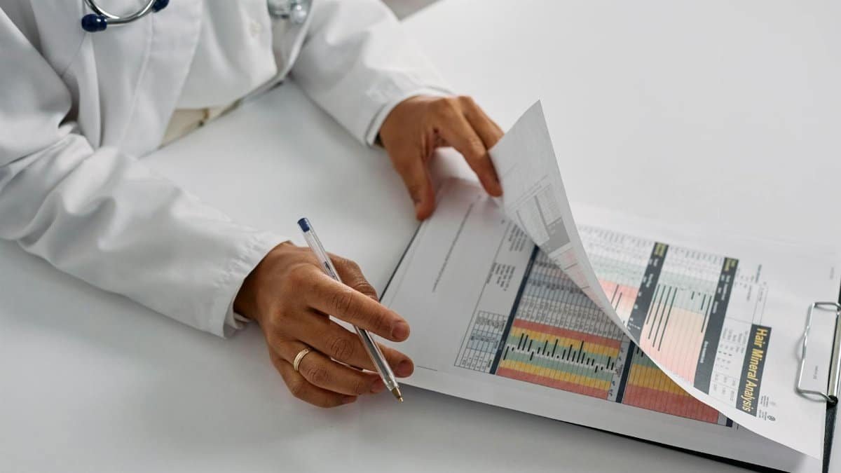 A medical professional checking patient reports with a clipboard in an office setting.