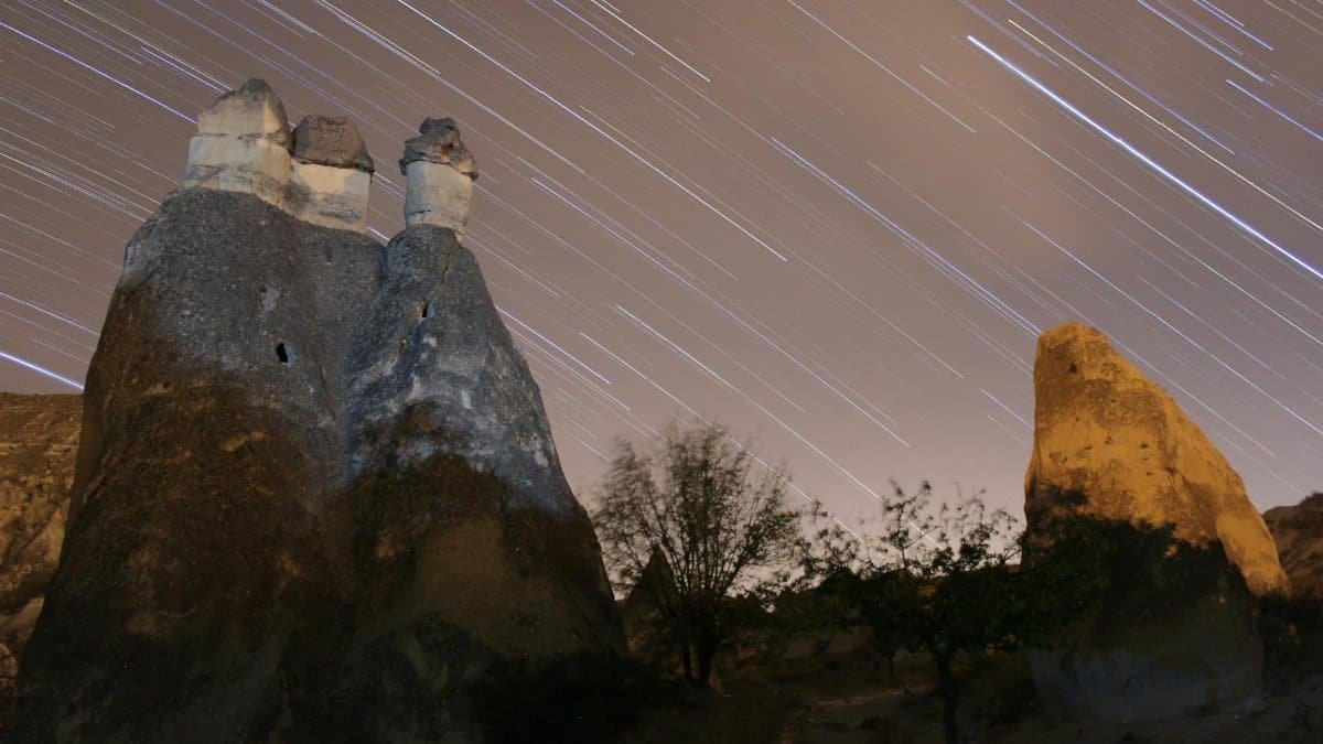 Stunning star trails over unique fairy chimneys in Cappadocia, Turkey.
