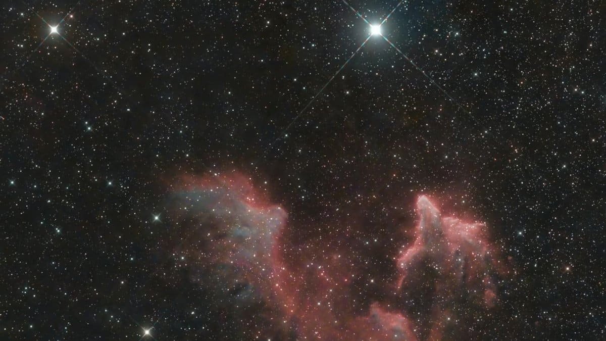 Stunning image of the IC 59 nebula in the constellation Cassiopeia with surrounding stars.