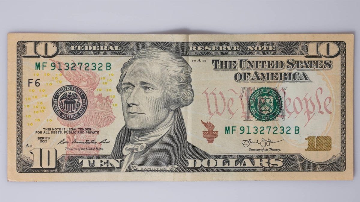 Detailed view of a US ten-dollar bill featuring Alexander Hamilton.