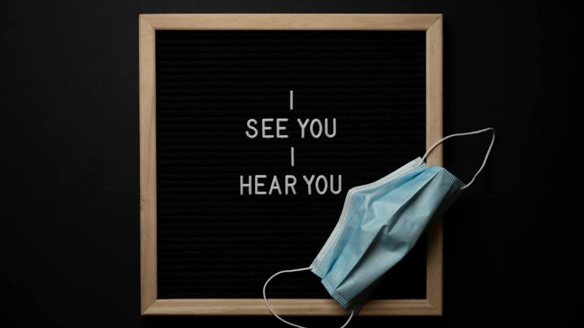 Inspirational text with a face mask displayed on a blackboard, highlighting health awareness.