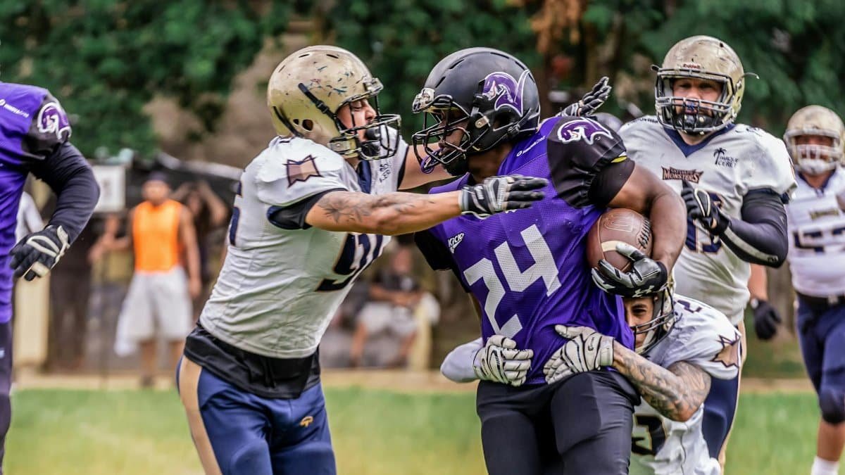 Dynamic scene of an American football game in action, showcasing teamwork and athleticism.