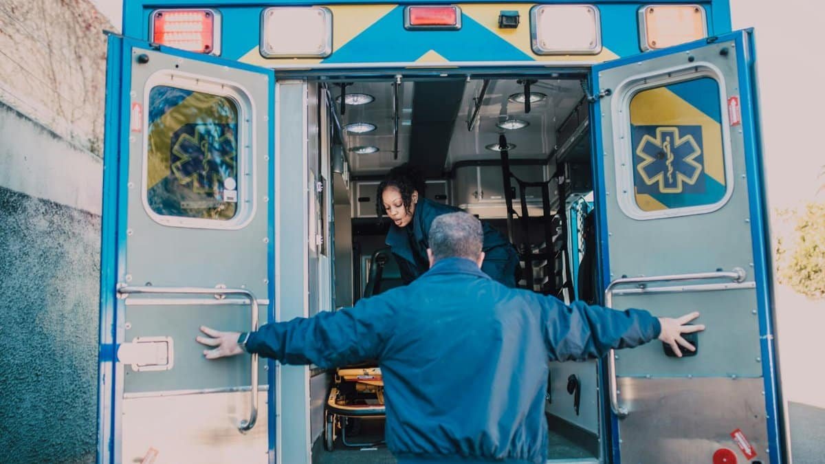 Paramedics load equipment into an ambulance, readying for an emergency call.