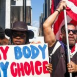 A vibrant group of diverse protesters in New York City advocates for bodily autonomy.
