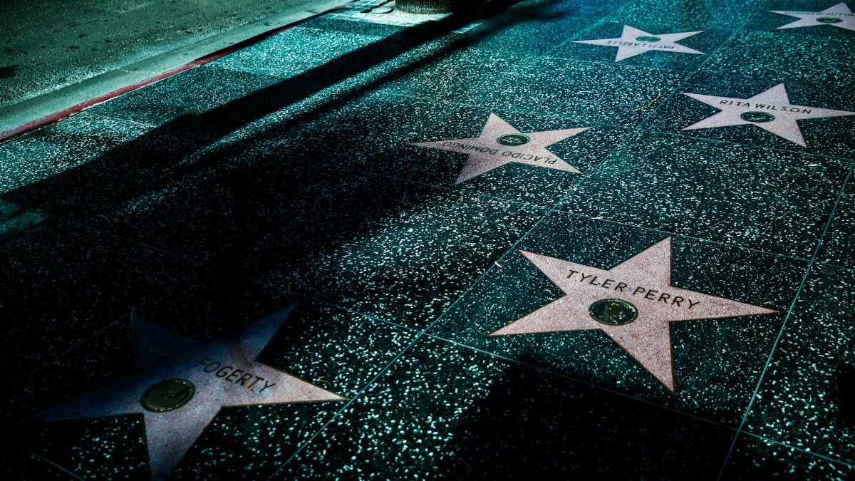 Night view of Hollywood Walk of Fame stars showcasing celebrity names and iconic design.