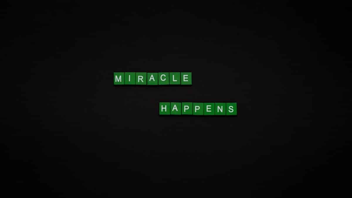 Motivational image featuring the words 'Miracle Happens' using green tiles on a black backdrop.