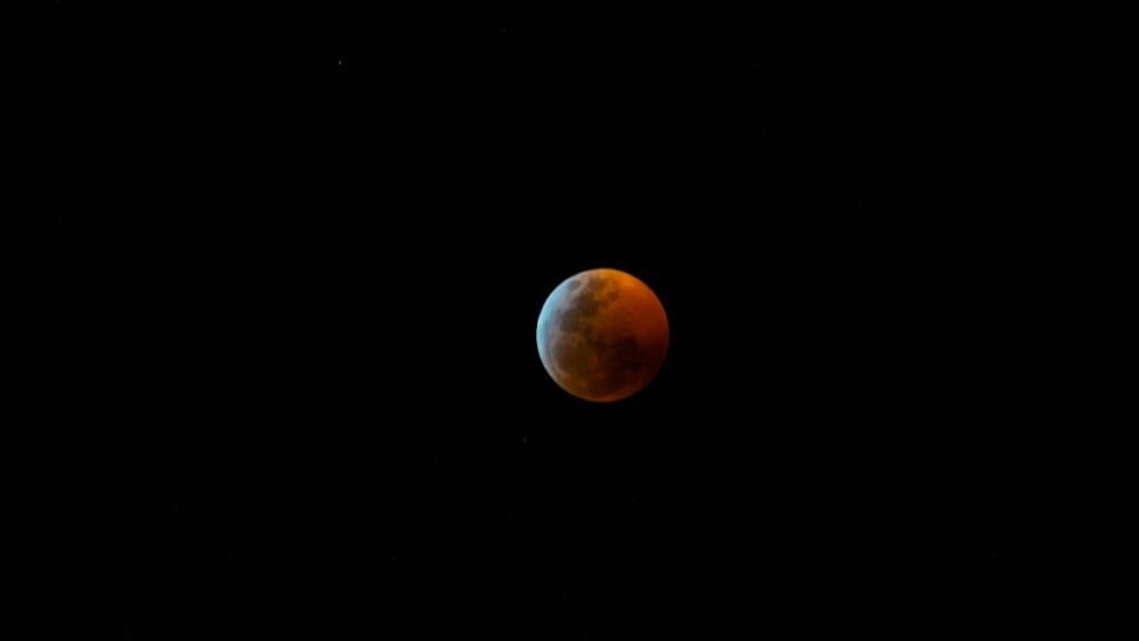 Captivating view of the blood moon during a total lunar eclipse against the night sky.