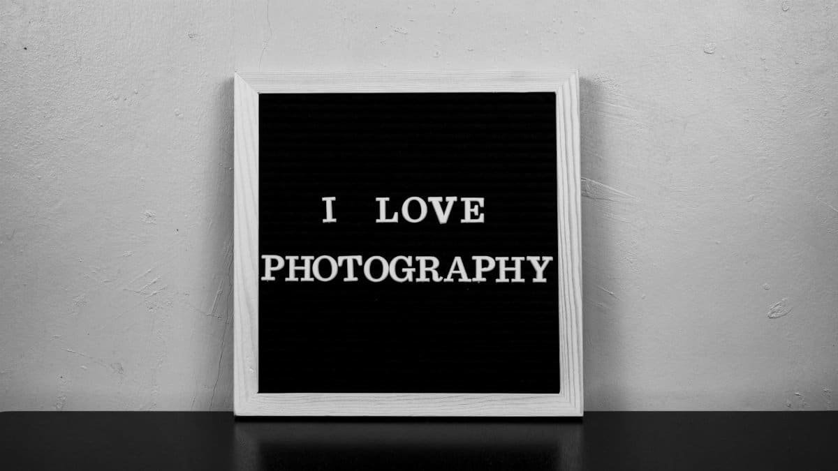 Black and white photo of a letter board with the quote 'I Love Photography.'