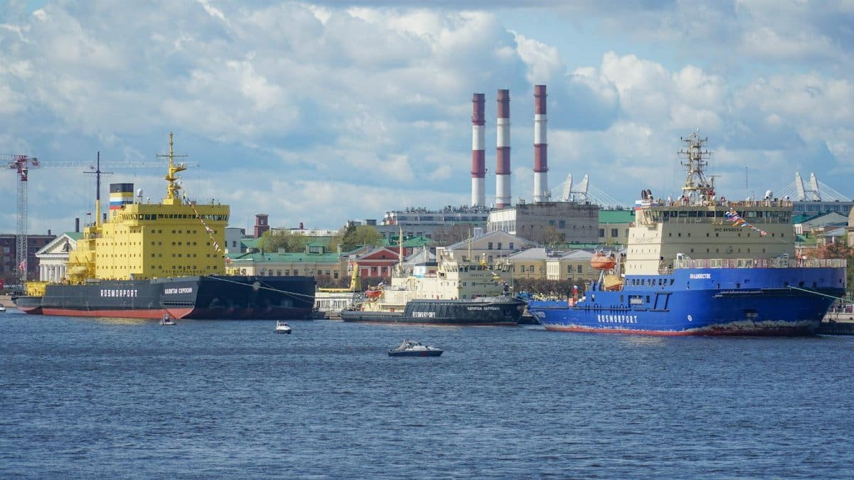Icebreakers docked at Saint Petersburg harbor under a sunny sky, highlighting maritime industry.
