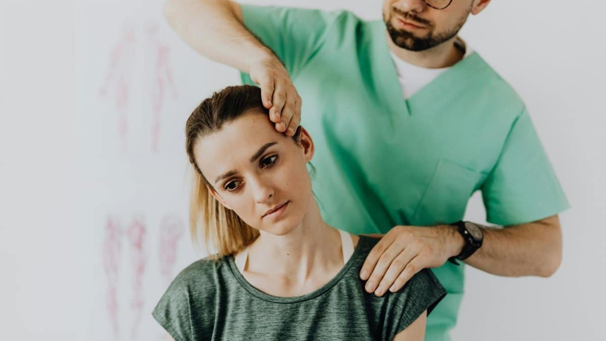 A chiropractor performs therapeutic neck adjustments on a patient for pain relief.