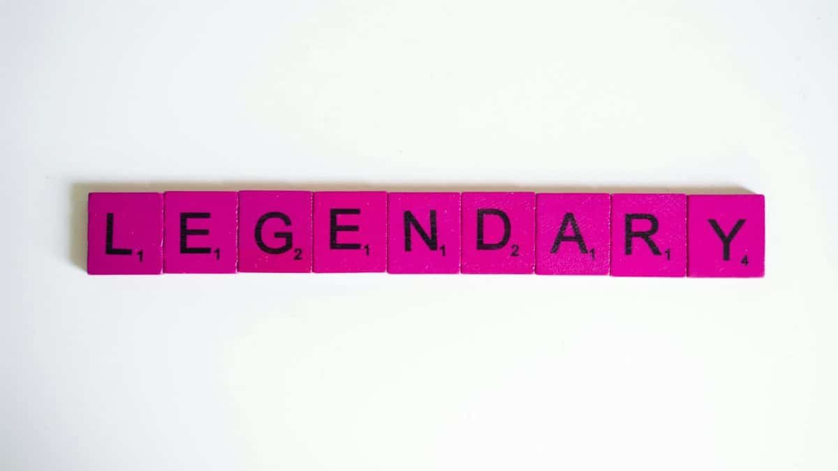 Pink Scrabble tiles spelling 'Legendary' on a white background, perfect for design themes.