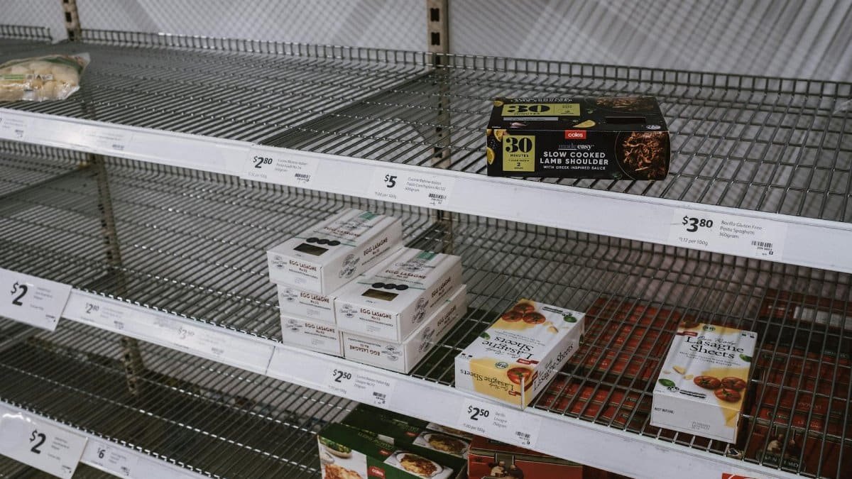 Image of partially empty grocery shelves in Sydney highlighting food scarcity.
