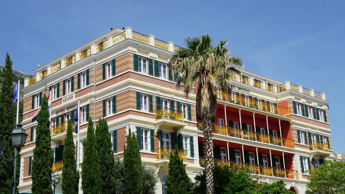 Stunning exterior view of the Hilton Imperial Hotel with vibrant balconies in Dubrovnik.