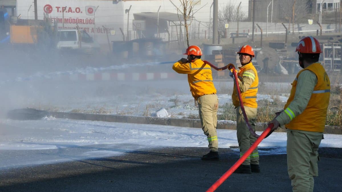 Firefighters working to extinguish a fire using a hose in Batman, Türkiye.