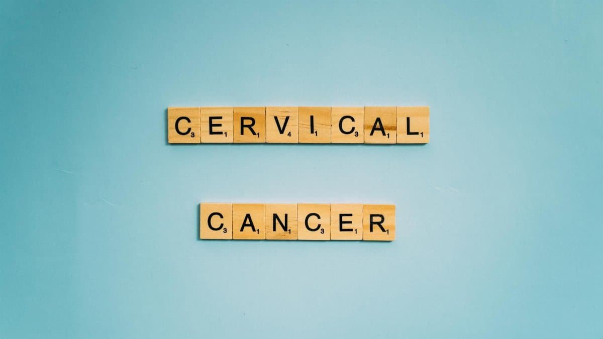 Scrabble tiles spelling 'Cervical Cancer' on a light blue background, symbolizing awareness.