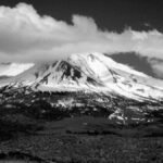 Black and white photo of Mount Shasta in California, showcasing its dramatic snow-capped peak.