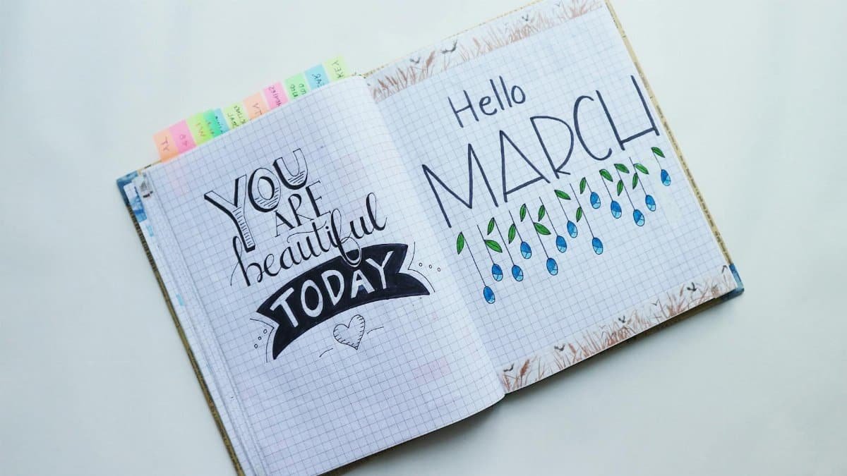 Open journal featuring 'Hello March' and an inspirational quote.