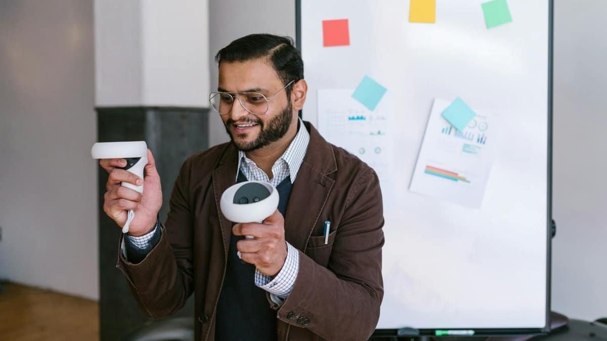 A business professional demonstrating virtual reality controllers during a presentation.