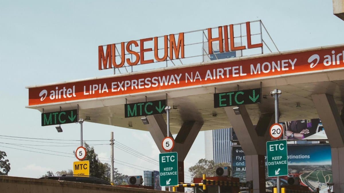 View of Museum Hill toll plaza in Nairobi, Kenya, displaying road signs and payment options.