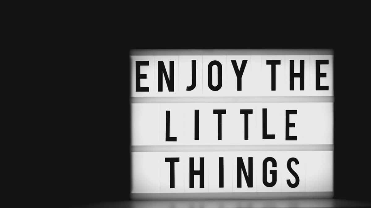 Black and white image of a lightbox displaying 'Enjoy the Little Things'. Perfect for motivation and positivity concepts.