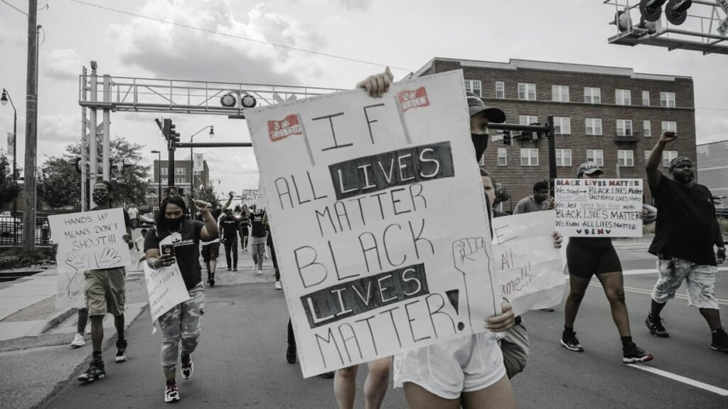 Demonstrators in Sanford, NC, rally for Black Lives Matter with signs advocating equality and justice.