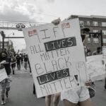Demonstrators in Sanford, NC, rally for Black Lives Matter with signs advocating equality and justice.