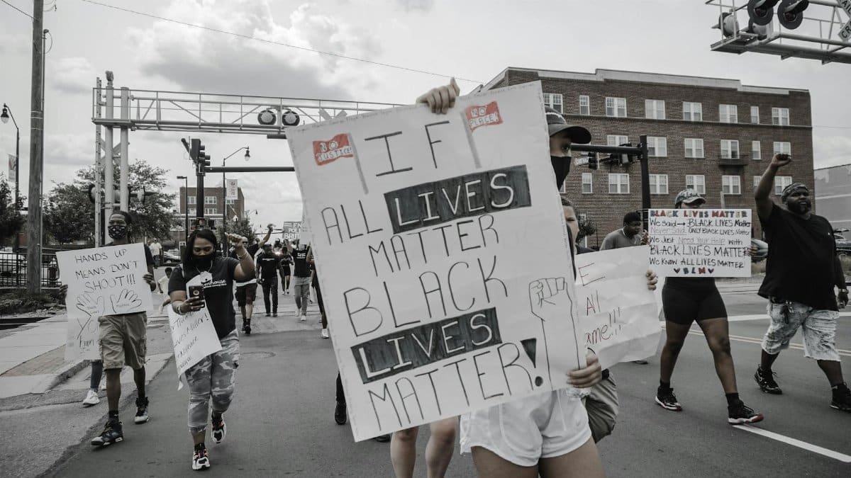 Demonstrators in Sanford, NC, rally for Black Lives Matter with signs advocating equality and justice.
