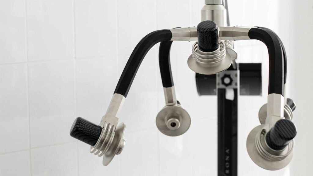 Contemporary laser machine with adjustable heads for weight loss placed in light room on white background in modern clinic with professional equipment