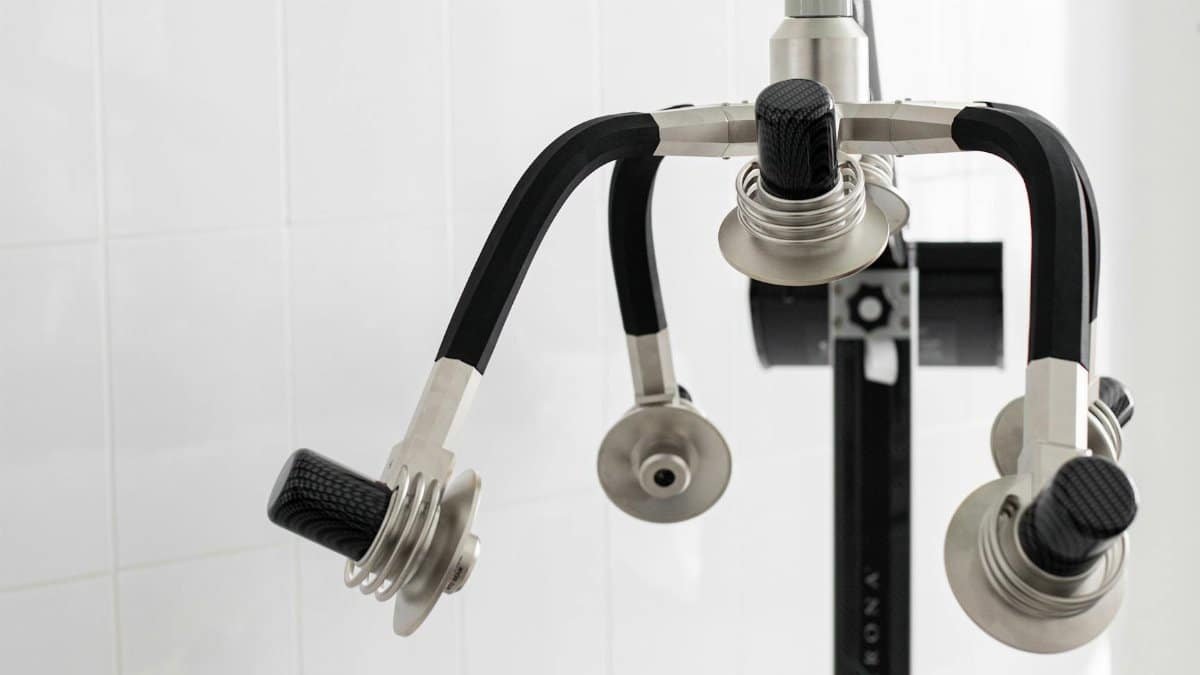 Contemporary laser machine with adjustable heads for weight loss placed in light room on white background in modern clinic with professional equipment