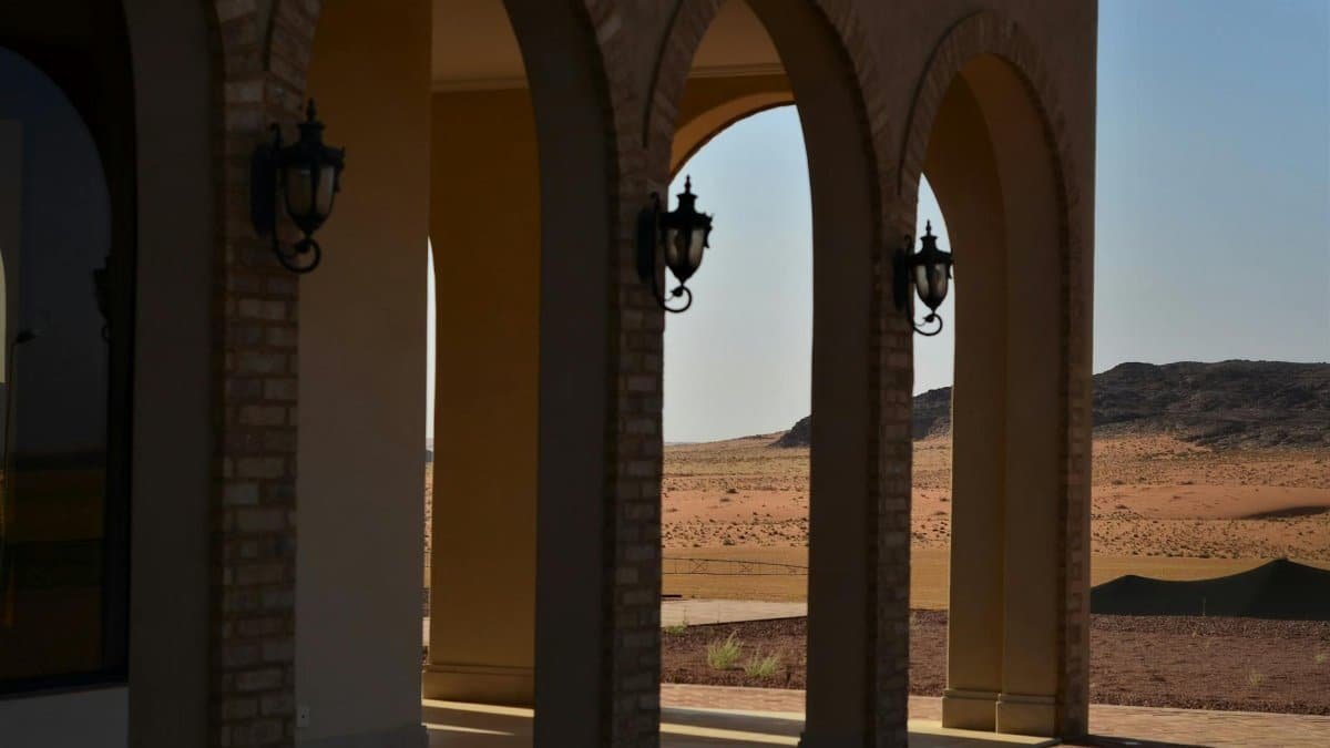 Elegant stone arches leading to a scenic desert view in Hail, Saudi Arabia.