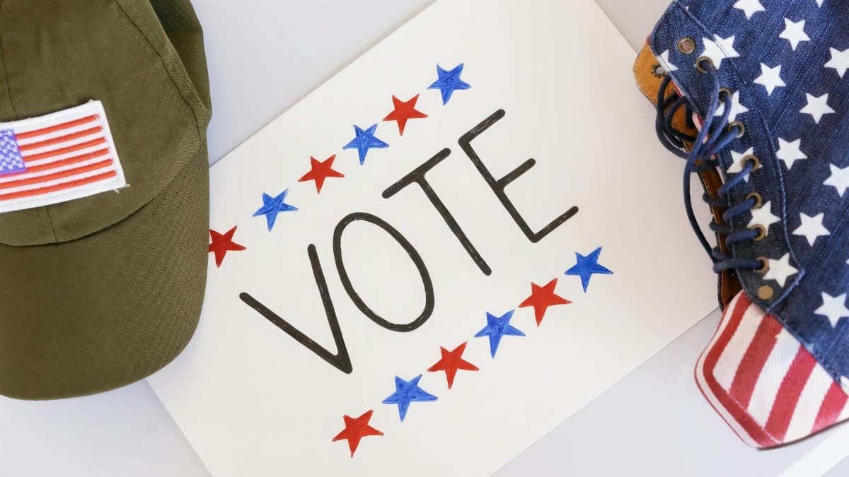 Flat lay of election-themed items promoting voting and democracy.